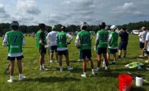 Players from 802 Lacrosse along watch action at the N.H. Invitational. (Kyle Devitte/NELJ)